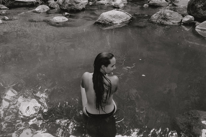 Woman sitting in a river