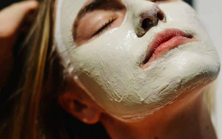 Woman with facial cream mask