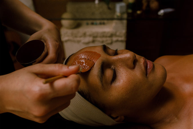 Woman having ointment applied applied to her face